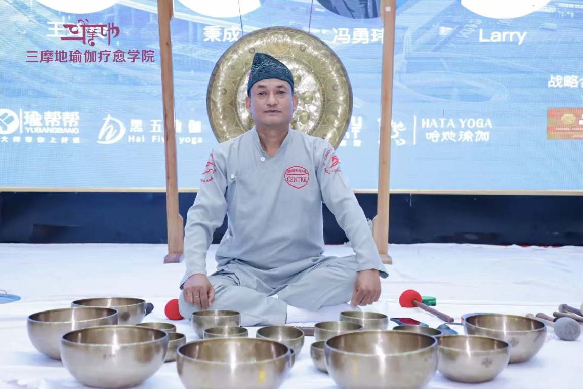 Master Saroj Shakya seated with singing bowls