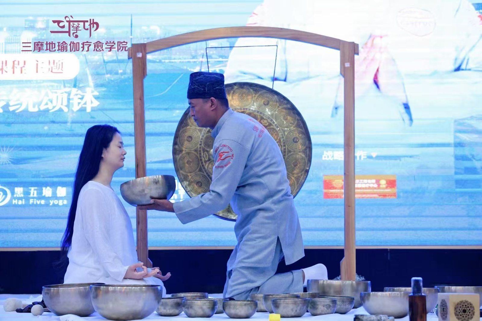Master Saroj Shakya demonstrating singing bowl healing technique